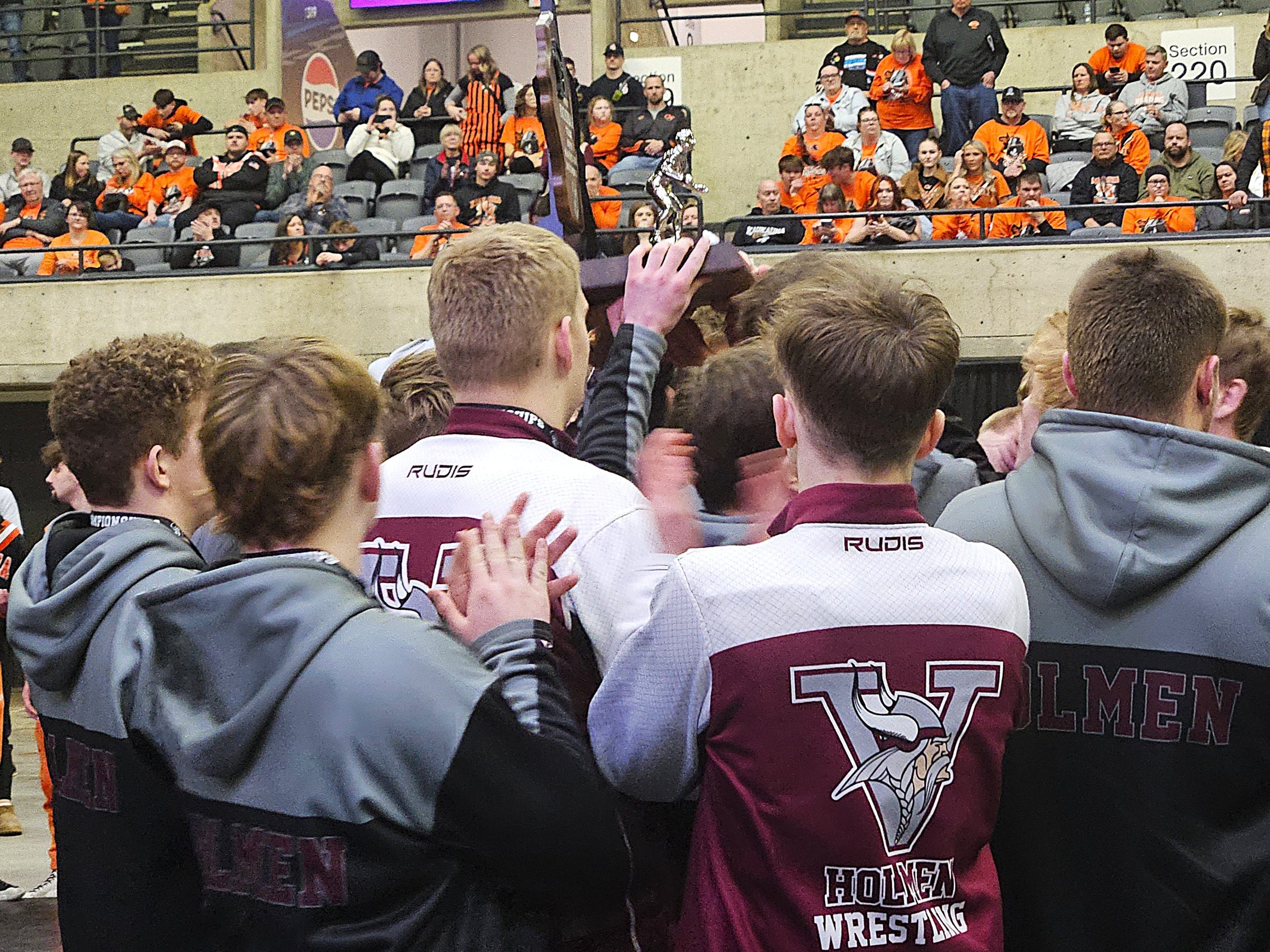 The Holmen wrestling team receives its runner-up trophy after losing to Kaukauna in the WIAA Division 1 team state finals. -- TODD SOMMERFELDT PHOTO