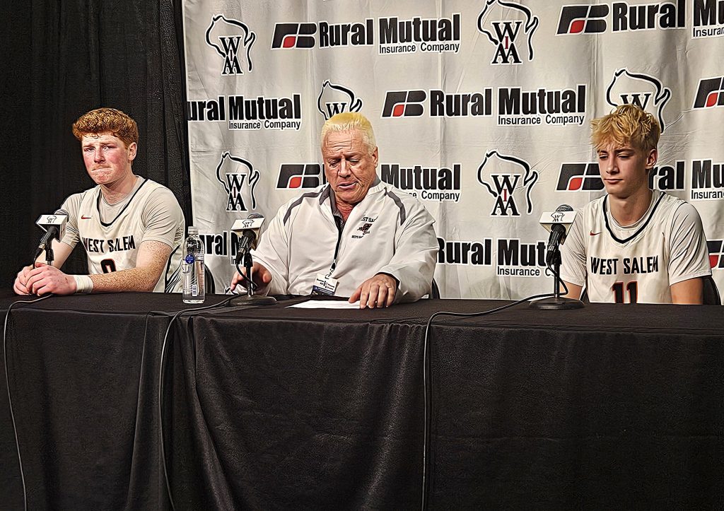Senior Tyson Labus, coach Shane Schmeling and junior Elliott Corcoran prepare to take questions from state media after a 64-58 loss to Whitefish Bay in a WIAA Division 2 state boys basketball semifinal on Friday. -- TODD SOMMERFELDT PHOTO