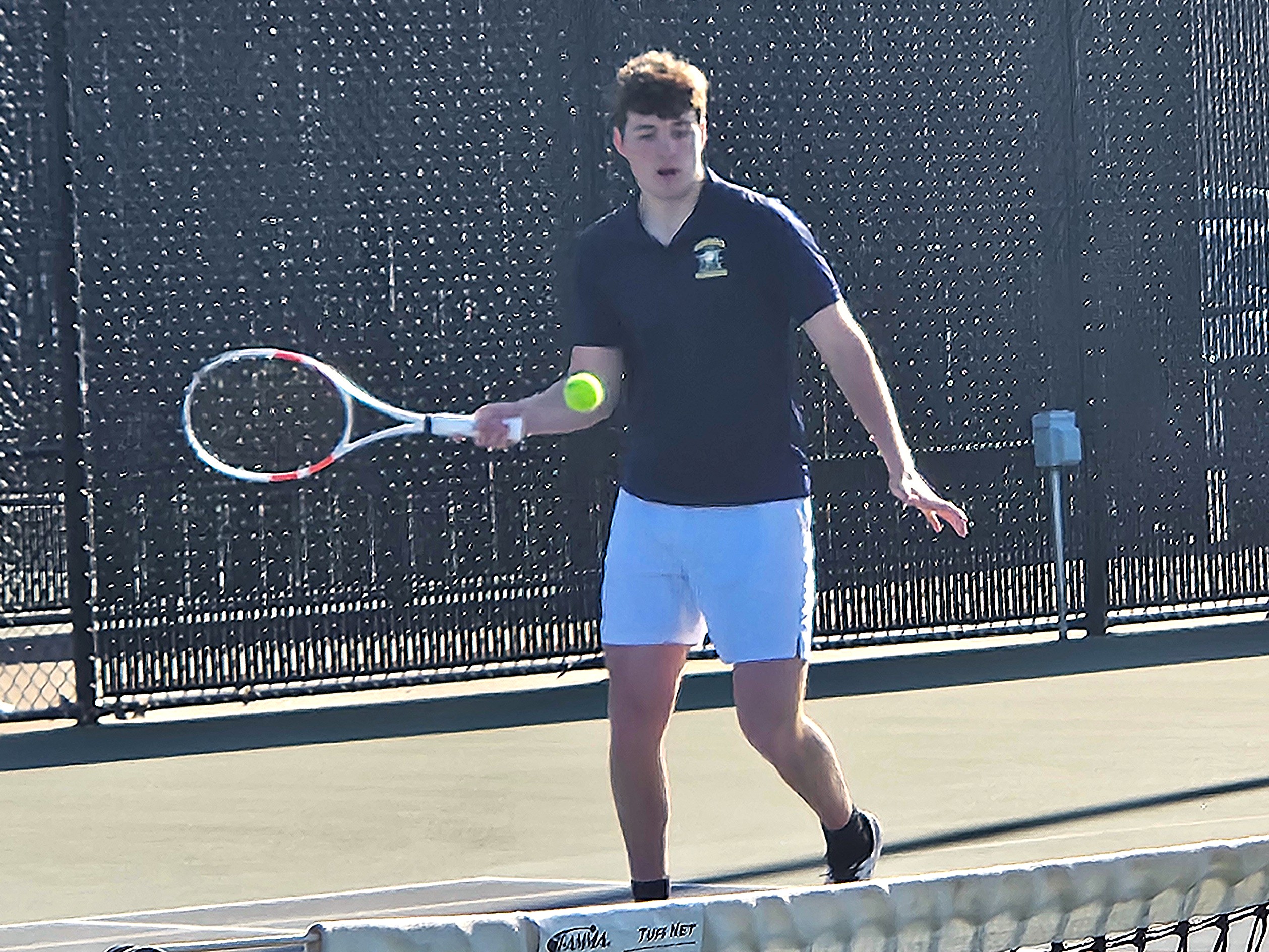 Isaac Capelli returns a shot during his No. 2 singles match for Aquinas against West Salem on Friday. -- TODD SOMMERFELDT PHOTO