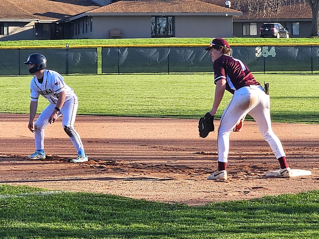 Aquinas junior Jonny Deets gets a lead from first base during Thursday's doubleheader against Holmen. -- TODD SOMMERFELDT PHOTO