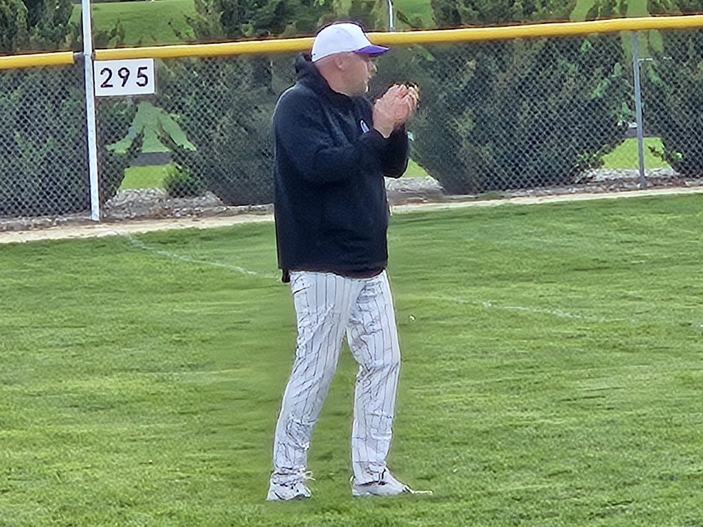 Onalaska baseball coach Craig Kowal applauds his team during Tuesday's game at Luther. -- TODD SOMMERFELDT PHOTO