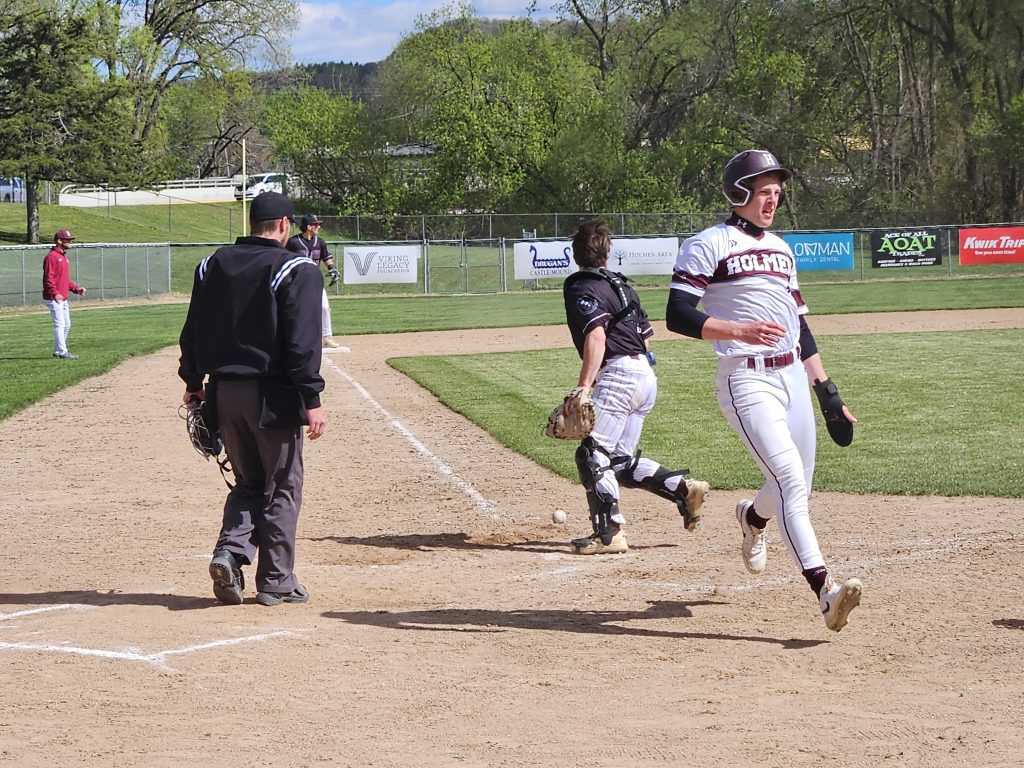 Holmen outfielder Joe Meeter scores a run during the first game of a doubleheader sweep over Menomonie. -- TODD SOMMERFELDT PHOTO
