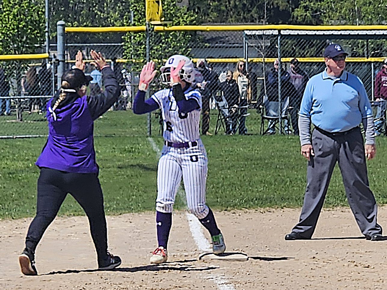 Onalaska coach Mesa Heit and Stdney Krause celebrate a triple by Kraus during a game against Menomonie. -- TODD SOMMERFELDT PHOTO