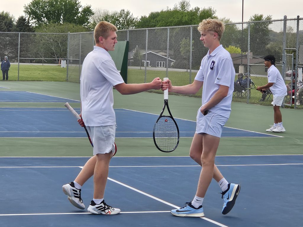 Onalaska's Porter Mallady and Elliot Glebke fist bump during their No. 1 doubles match against West Salem on Monday. -- TODD SOMMERFELDT PHOTO