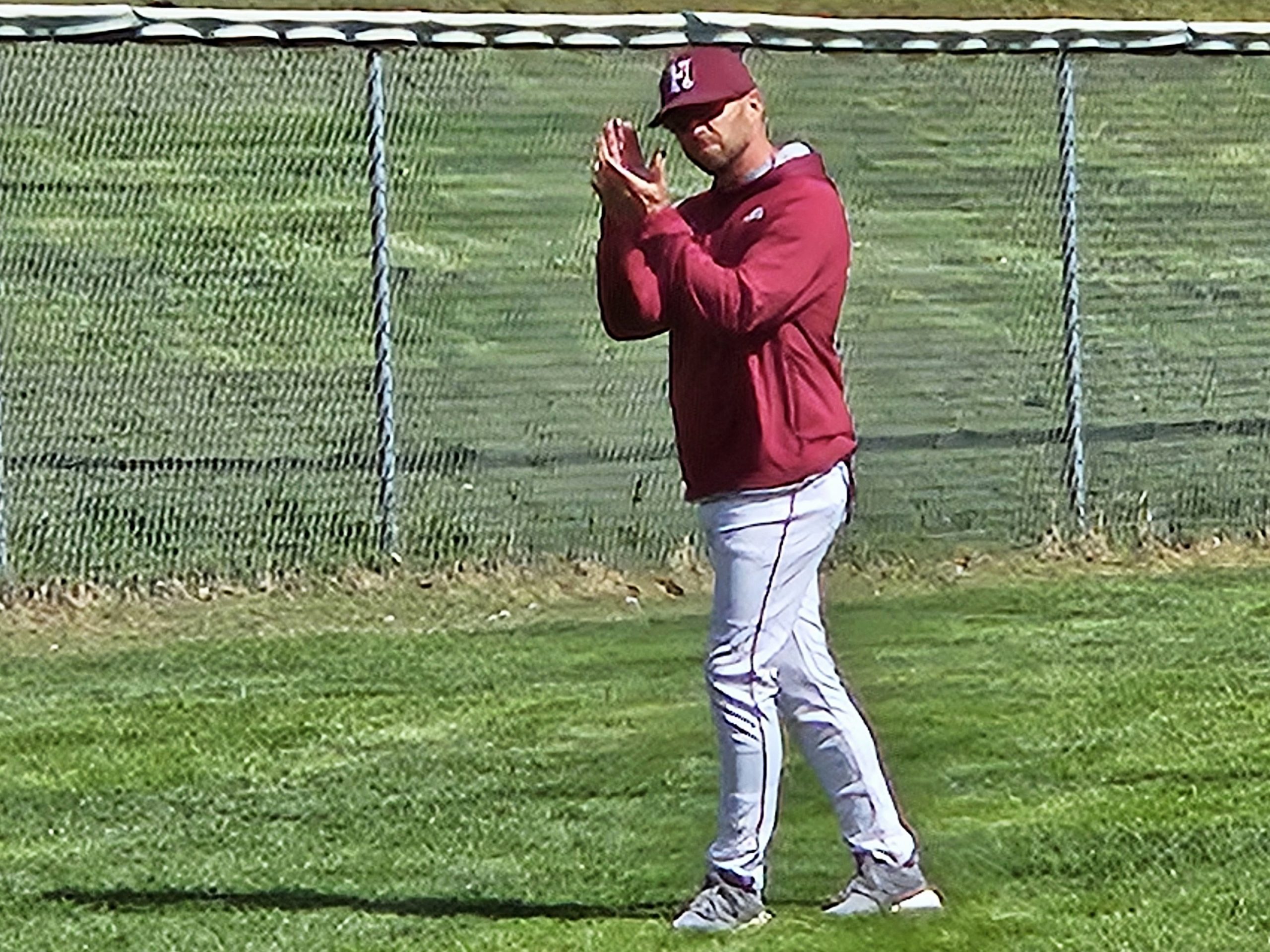 Holmen baseball coach Andy Palmer encourages one of his players at the plate. -- TODD SOMMERFELDT PHOTO
