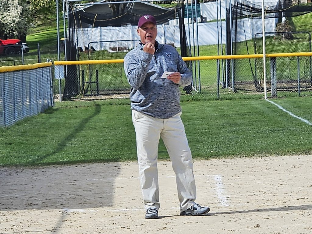Holmen softball coach Dan Stuhr communicates with one of his players during at at-bat. -- TODD SOMMERFELDT PHOTO