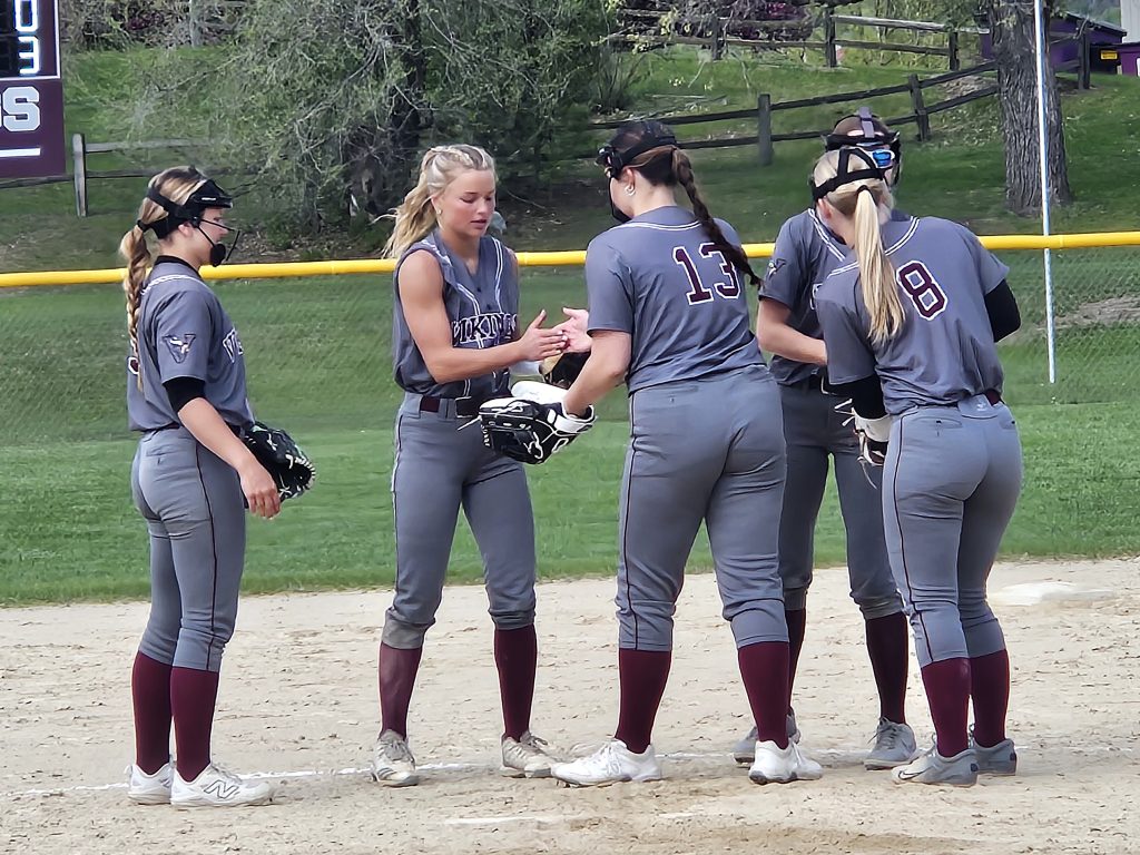 The Holmen softball team's infield meets in the circle. -- TODD SOMMERFELDT PHOTO