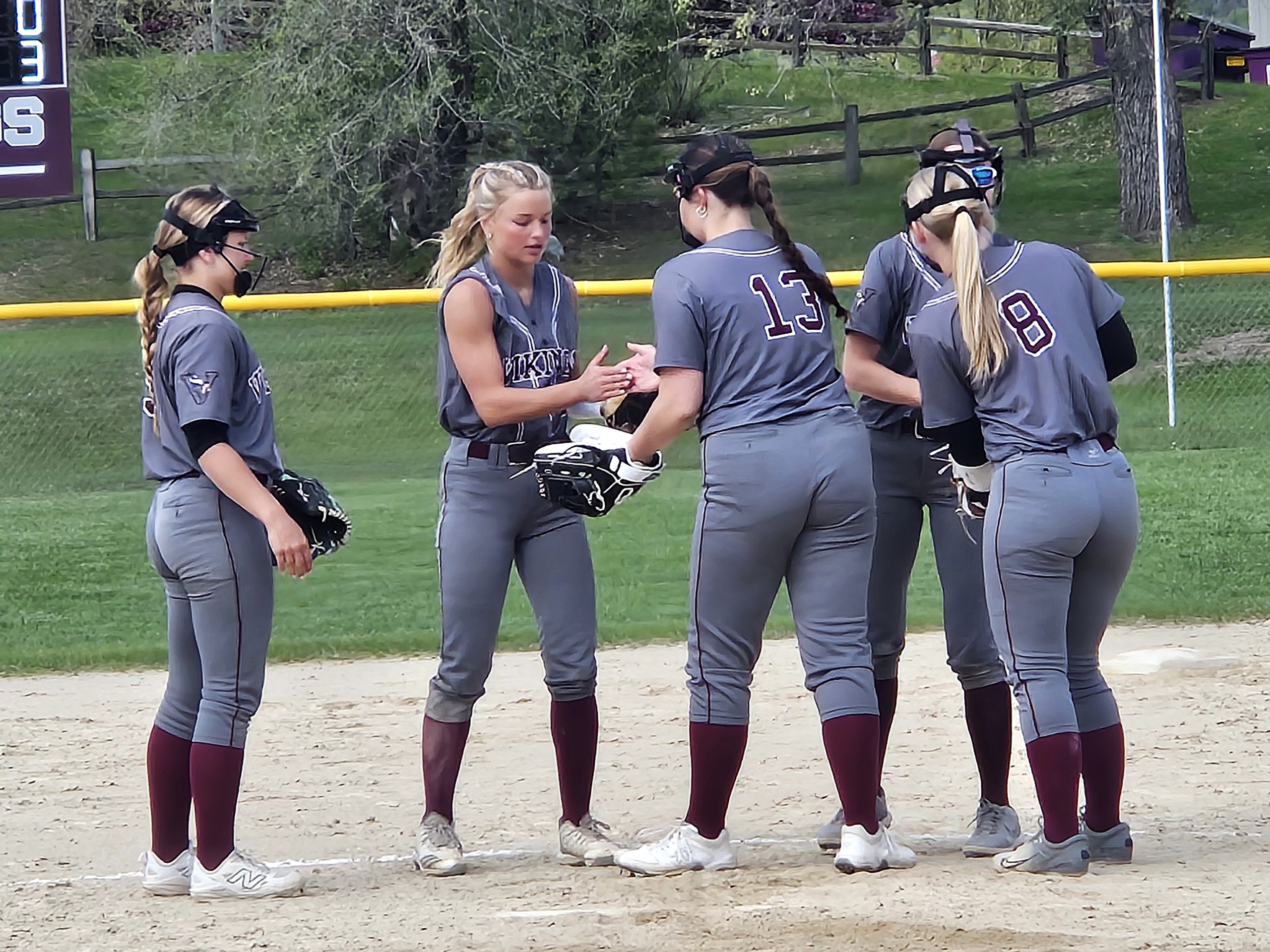 The Holmen softball team's infield meets in the circle. -- TODD SOMMERFELDT PHOTO