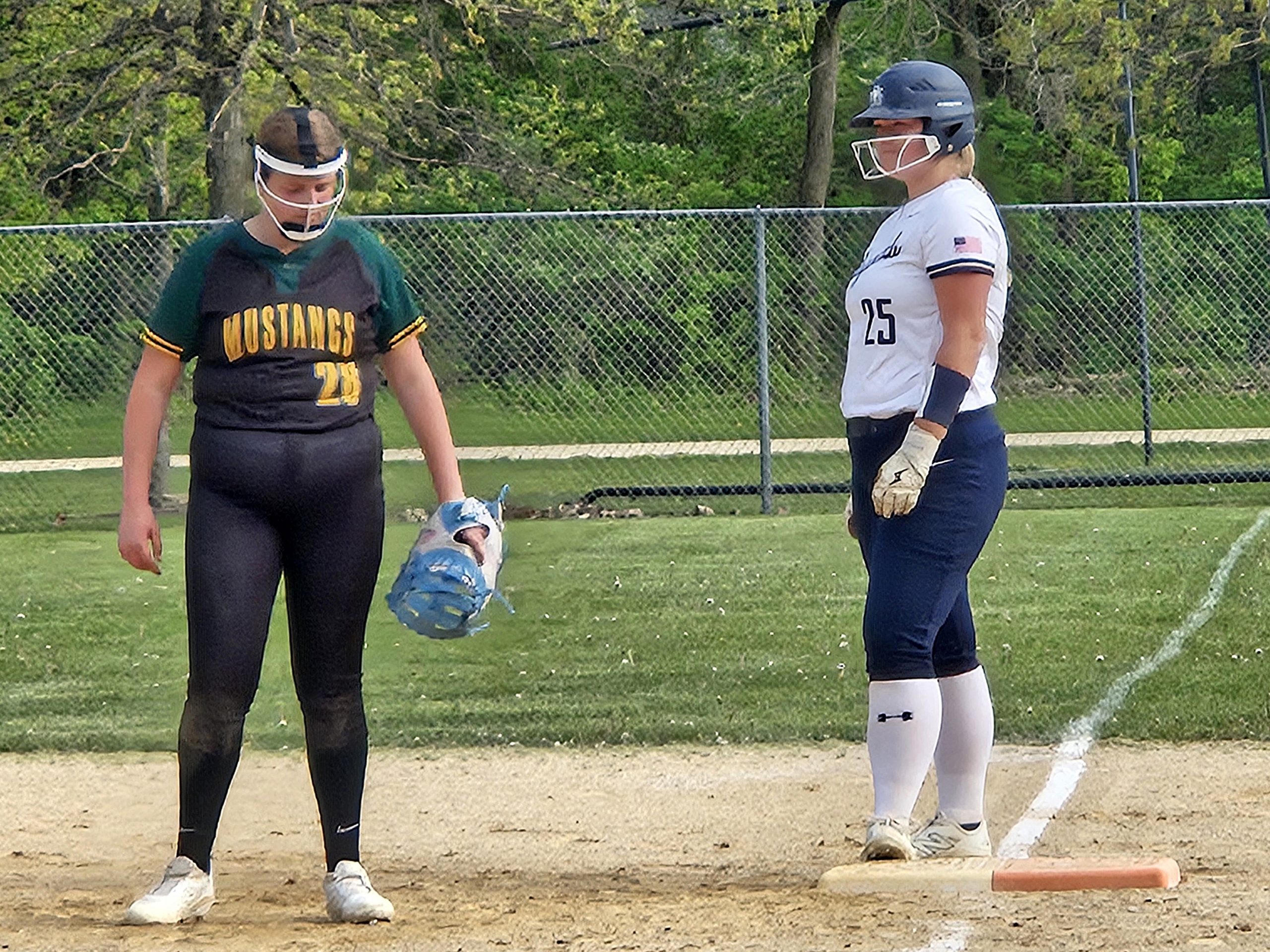 Ava Scholze stands on first base after hitting a single during an Aquinas softball game against Melrose-Mindoro. -- TODD SOMMERFELDT PHOTO