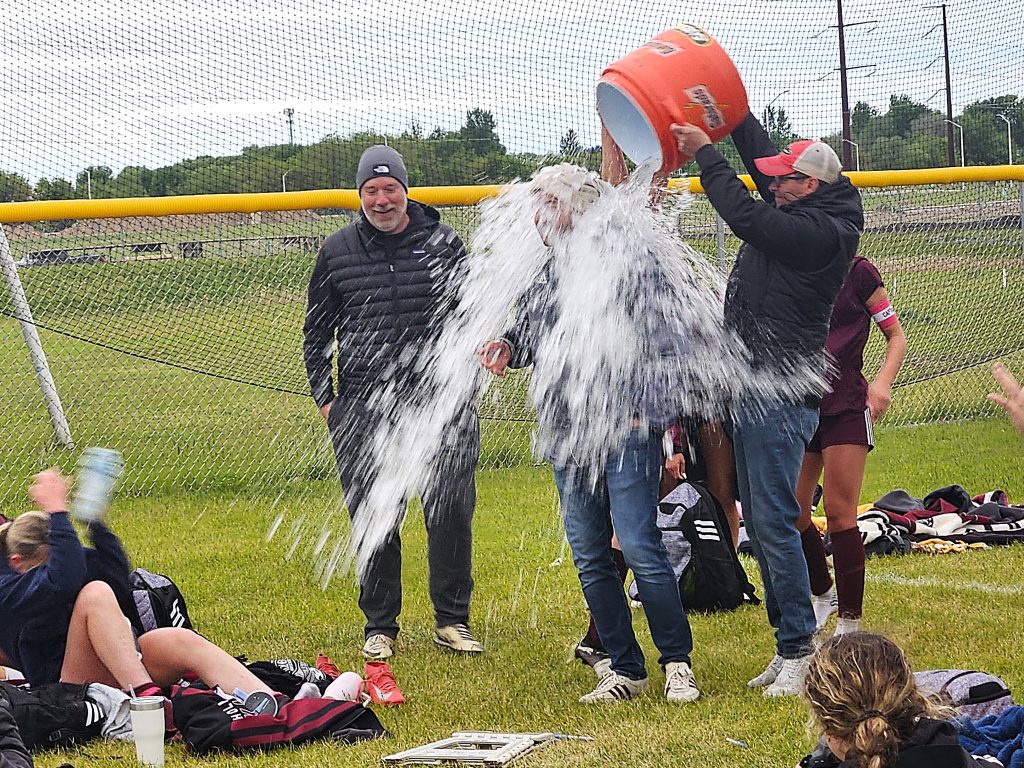 Holmen girls soccer coach Nick Schellenger is doused mid-speech after the Vikings won their first MVC championship on Tuesday. -- TODD SOMMERFELDT PHOTO