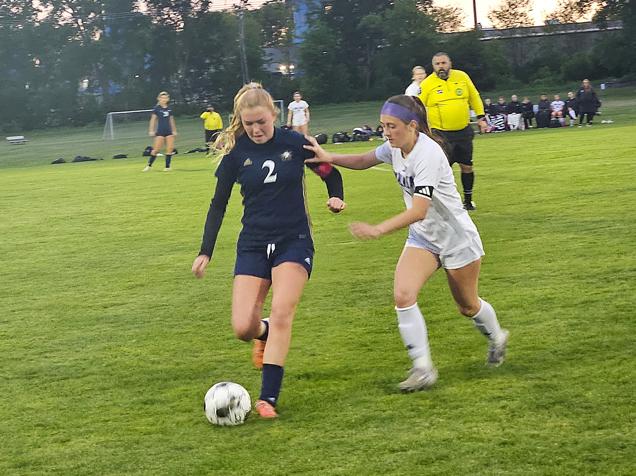 Onalaska sophomore Ellie Thesing pressures Aquinas senior Hayden Zehren during an MVC round-robin game on Thursday. Thesing scored three goals in a 3-2 Onalaska win. -- TODD SOMMERFELDT PHOTO