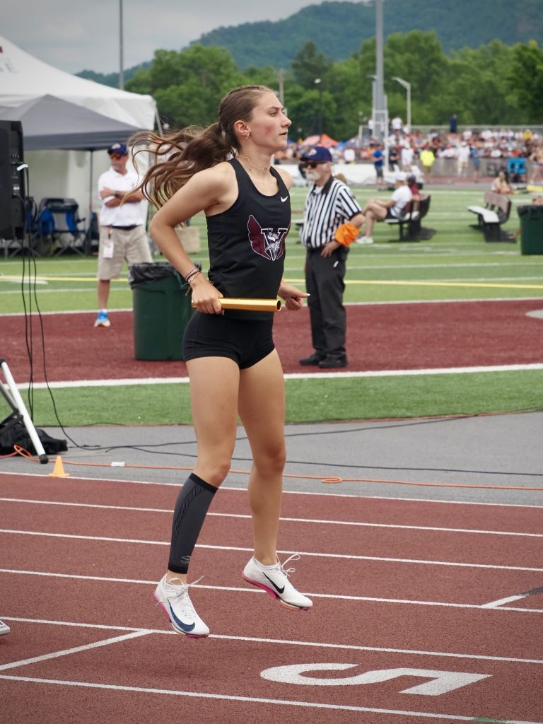 Holmen's Ava Newman warms up before starting her 400 relay team's prelim at the WIAA state track and field meet. -- TARA WALTERS PHOTO
