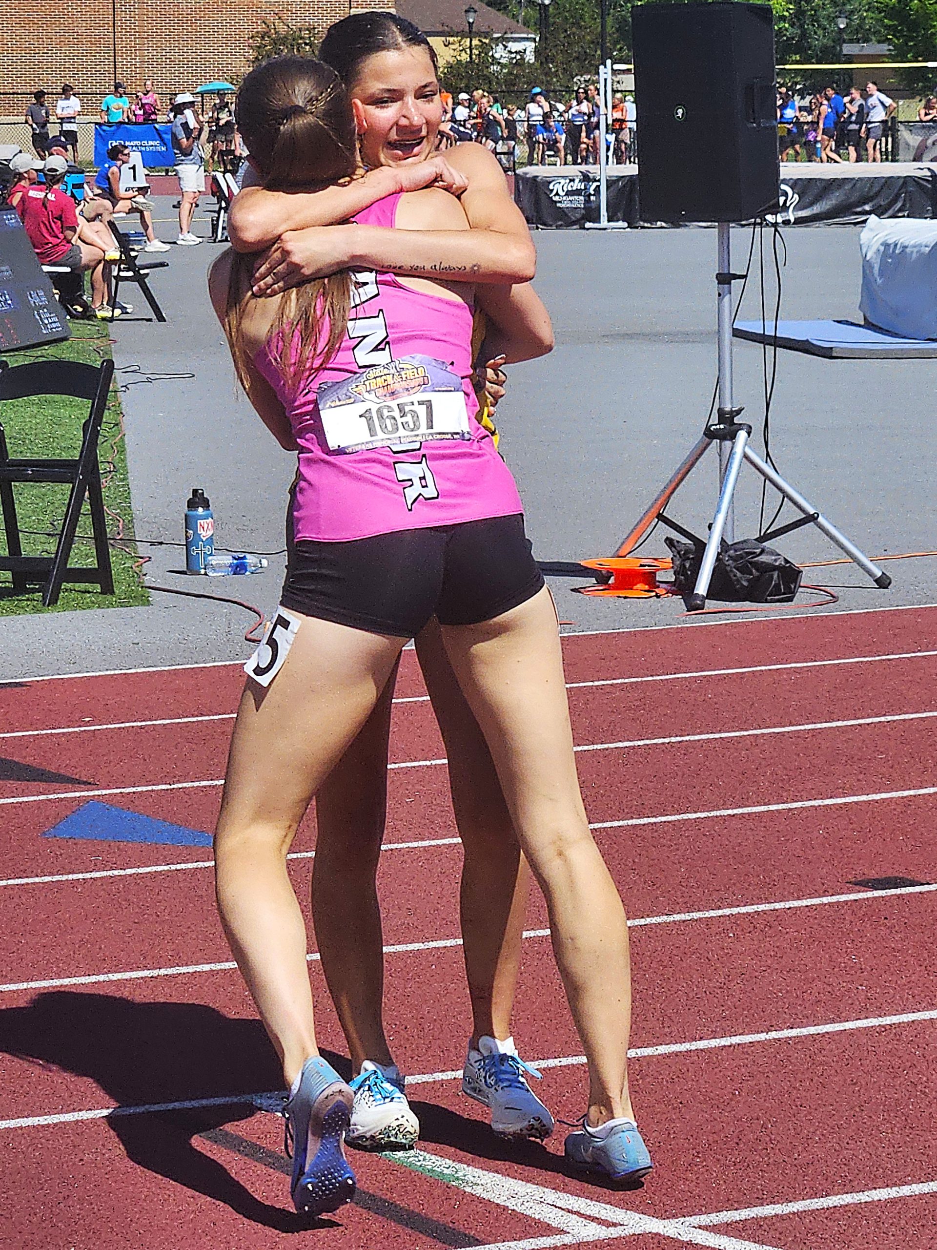 Melrose-Mindoro junior Bristol Coats and Bangor junior Jaycee Michek celebrating their 1-2 finish in the Division 3 300-meter hurdles at the WIAA state track and field meet. -- TODD SOMMERFELDT PHOTO