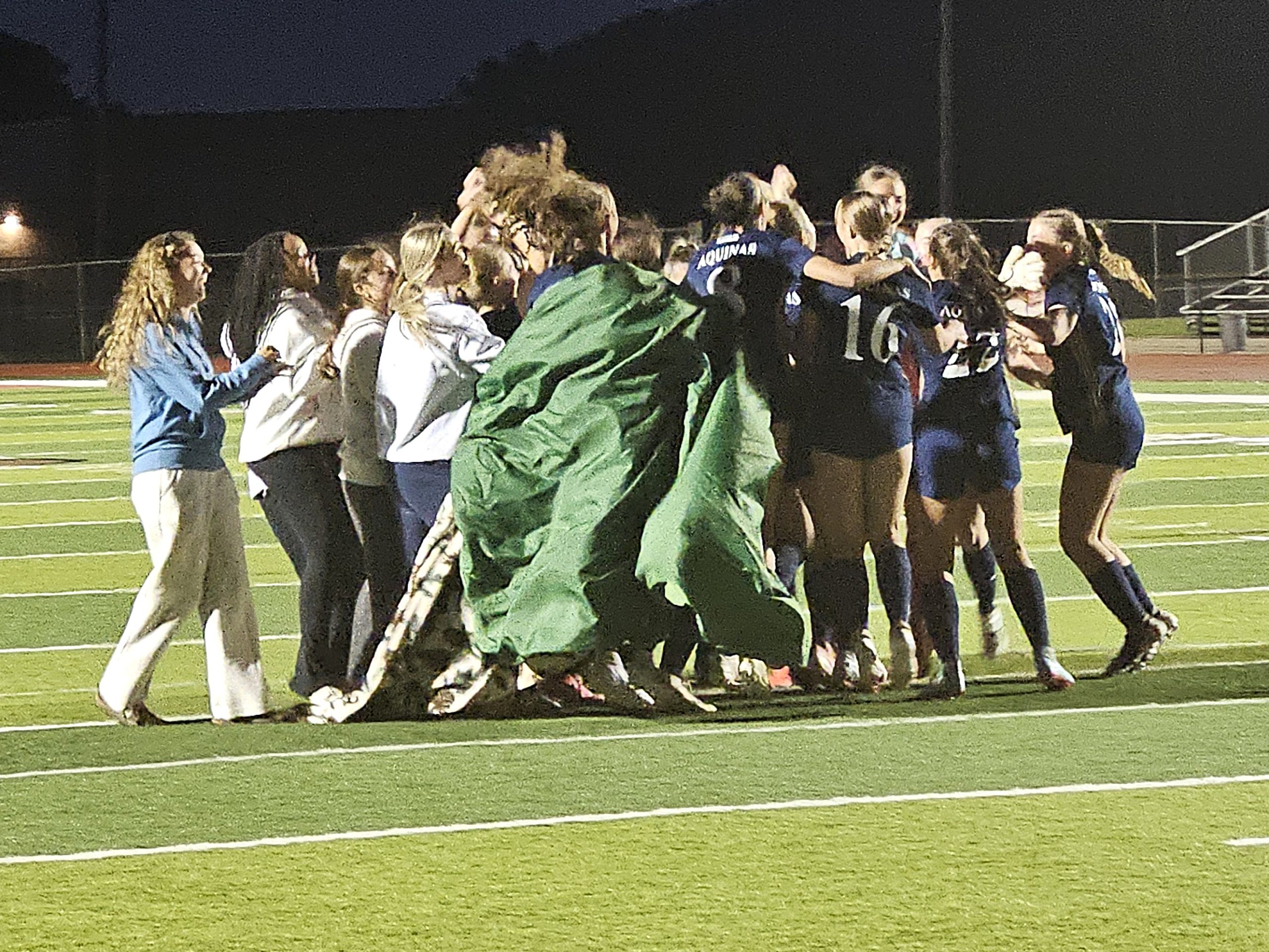 Players on the Aquinas girls soccer team celebrate a WIAA Division 4 sectional semifinal win over Lodi on Thursday. -- TODD SOMMERFELDT PHOTO